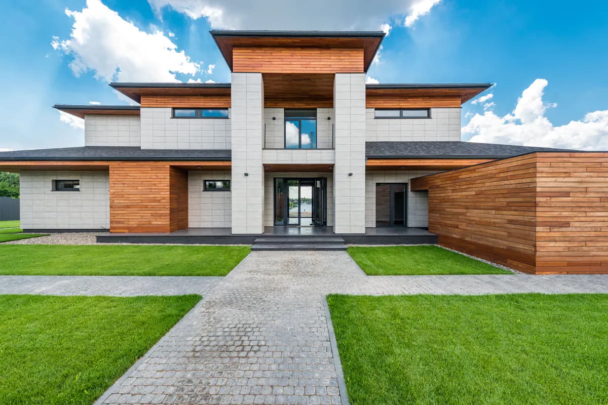 A modern villa photographed by day, relit for 19:00 — before